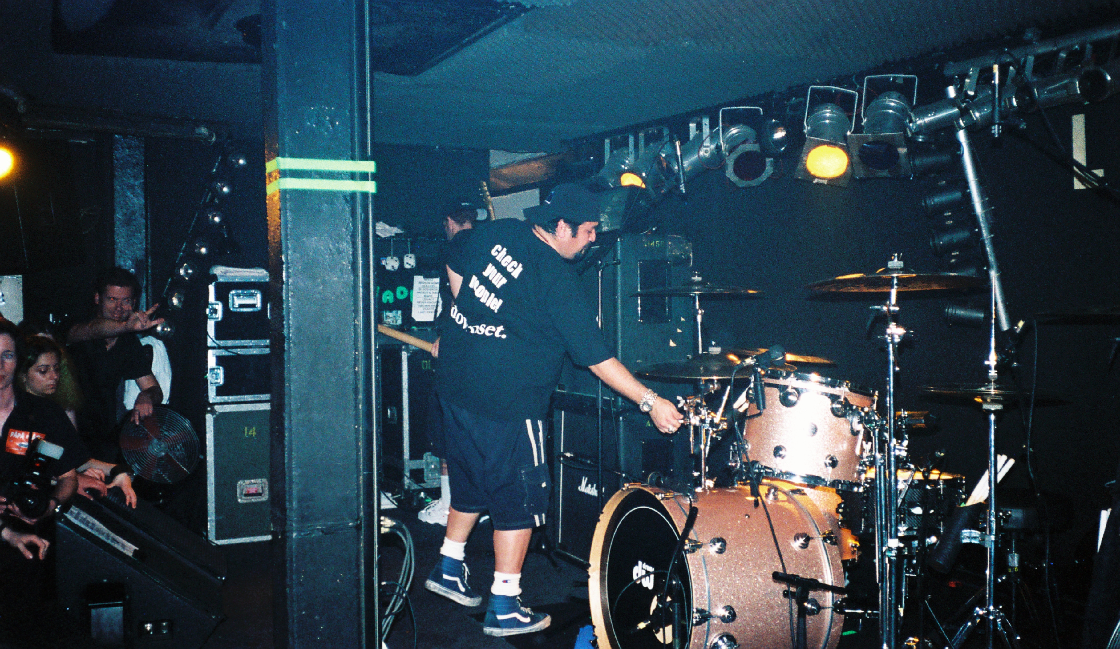 The Papa Roach drum tech adjusts the drums in preparation for the headliner