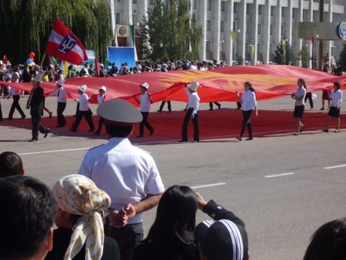 Youth carrying a giant flag of Kyrgyzstan