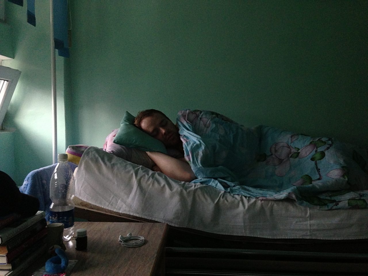 Judson recovering in a hospital bed after having an appendectomy in Bishkek.