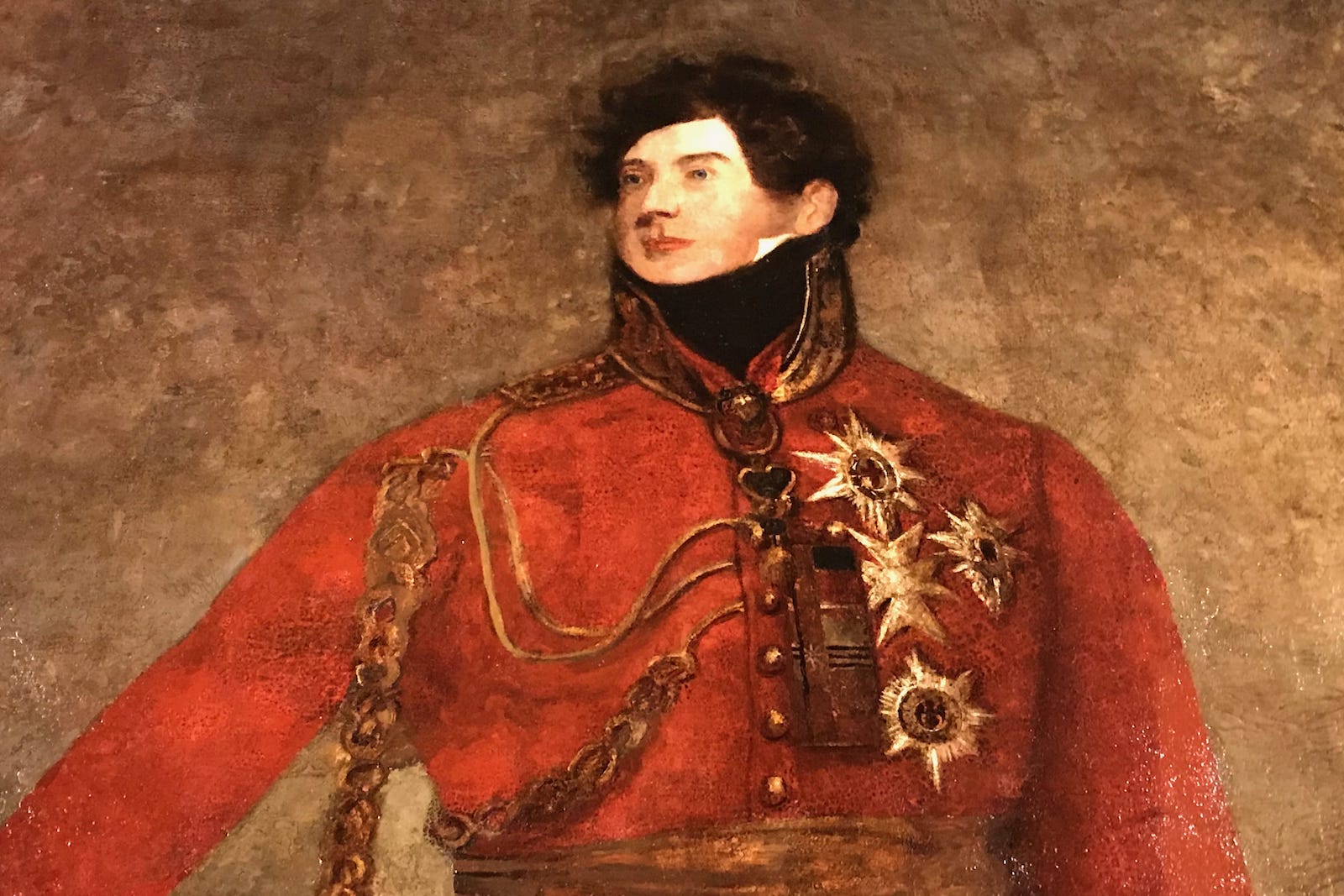 A royal man in red uniform is painted against a brown background