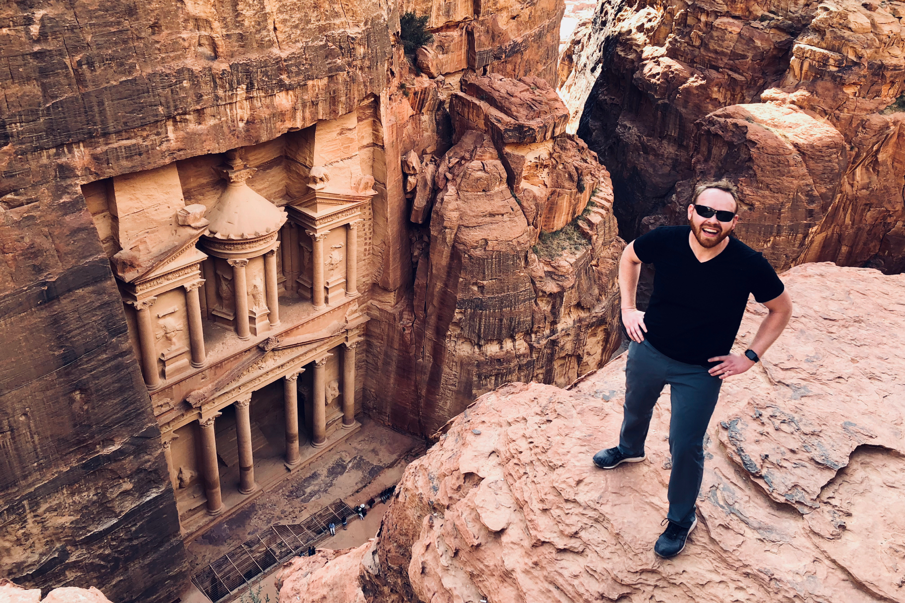 Judson stands on a ledge above The Treasury at Petra.