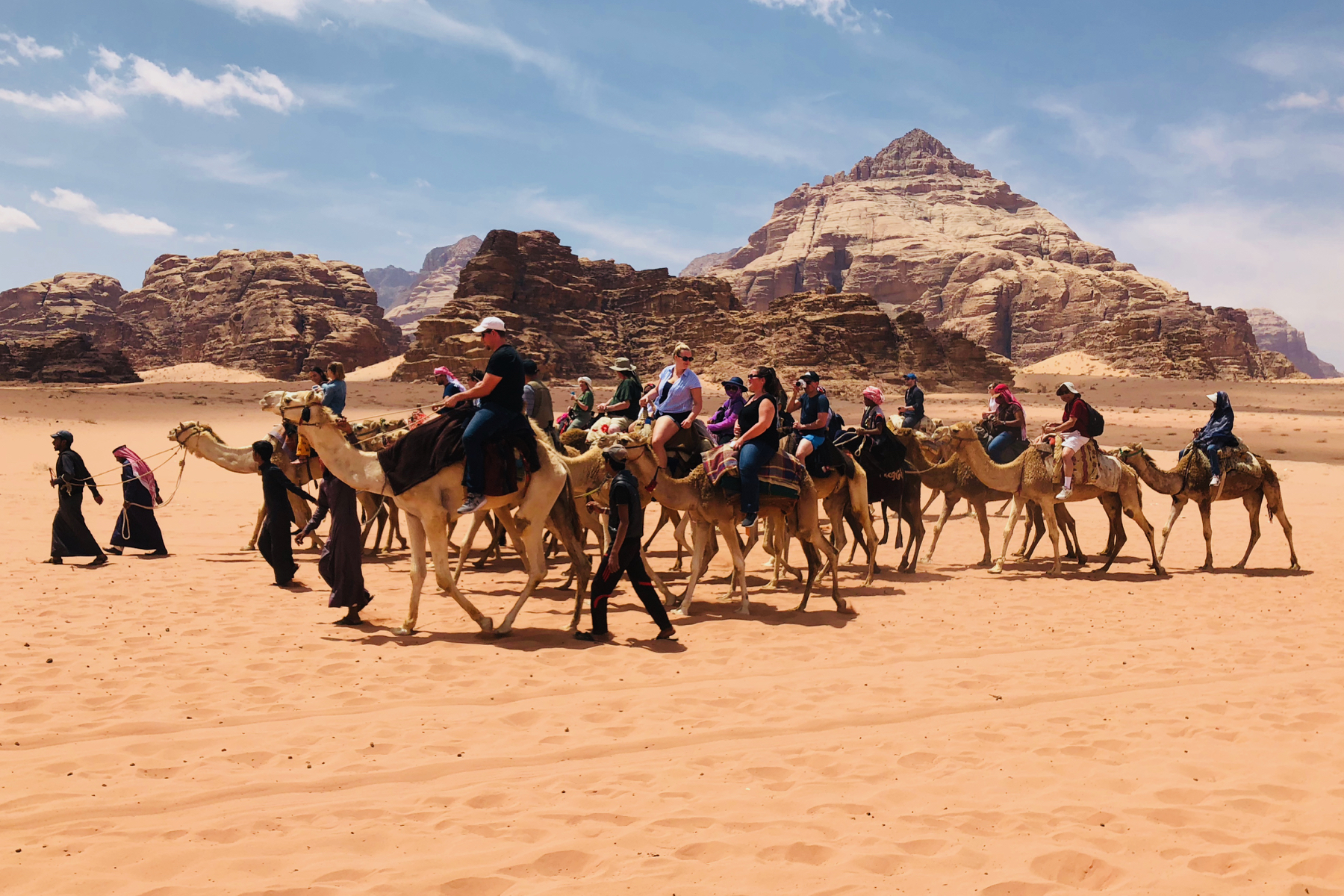 A tour group takes a camel safari in the Wadi Rum Desert in southern Jordan