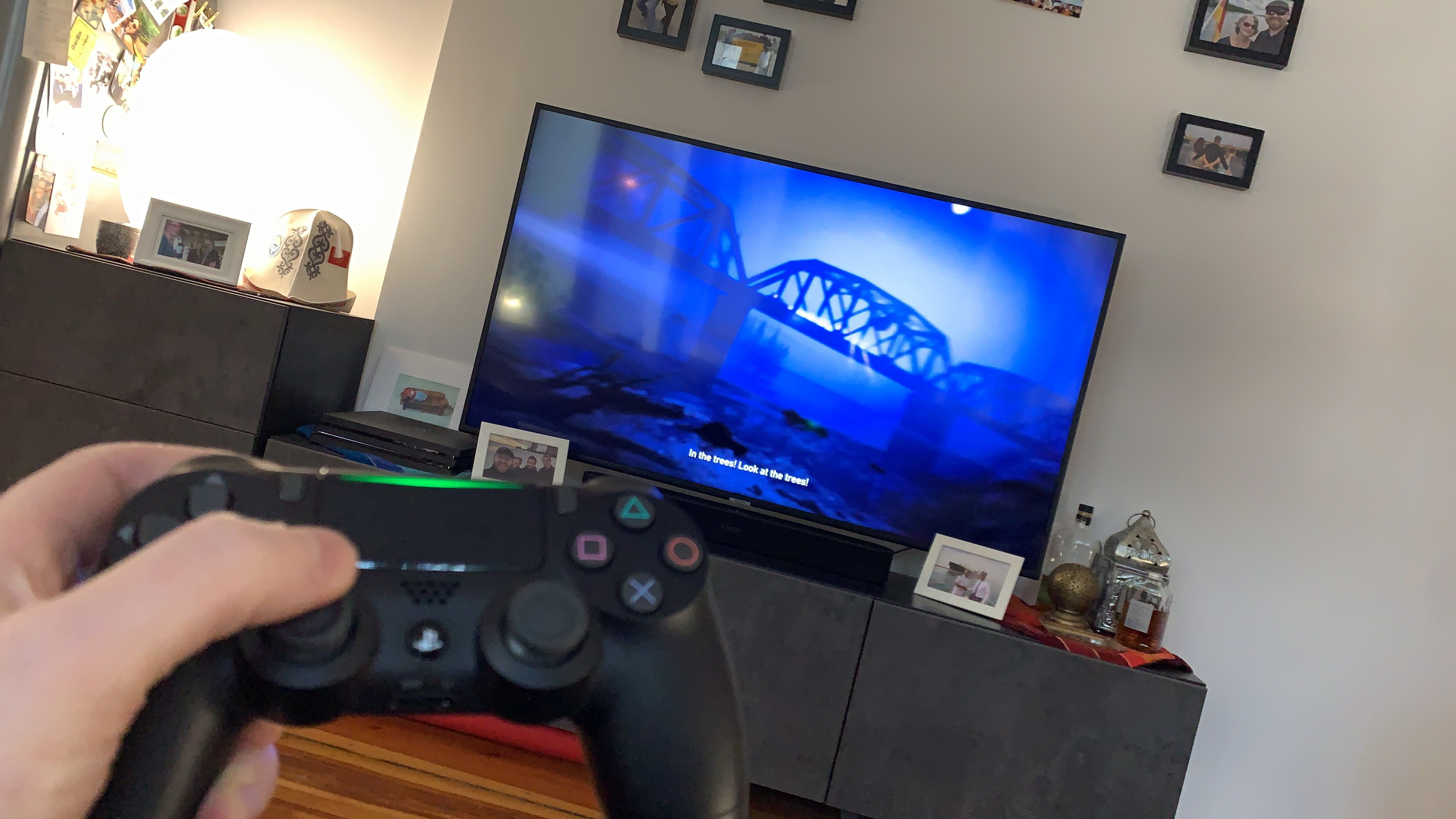 Showing off my PS4 controller at home with Unchartered four playing in the background
